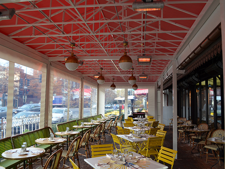restaurant seating area with red canopy providing solar protection